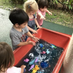 Enjoying water play with coloured ice!