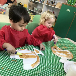 Isaac and Martha creating their golden fish craft!