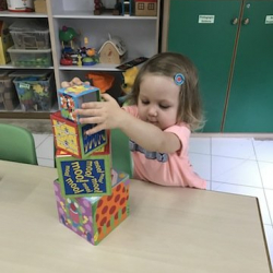 Steady hands.. Coco creating her tower. Well done!