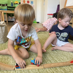 Raif and George are playing with the trains.