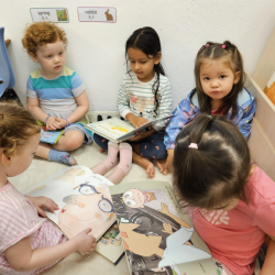 The girls were sharing the stories that they were reading.