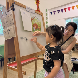 Ellie helping to put the zodiac animals up on the board during Mandarin!