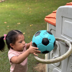 Harper practicing to throw the ball in the hoop!