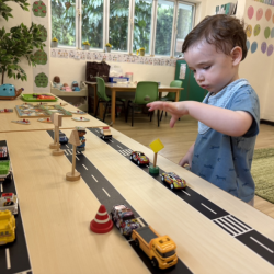 Liam enjoying to drive the cars along the road!