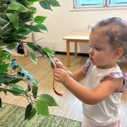 Sienna putting decorations on our tree for CNY!