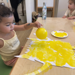 Skyla balloon painting the yellow colour monster!