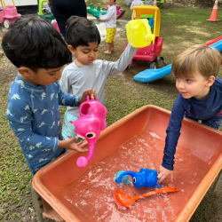 Aarav, Kai and Lao having fun at water play .