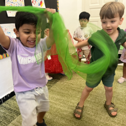 Leo and Kai having fun with scarf dance . 