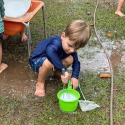 Leo whisking water and soap to create bubbles . 