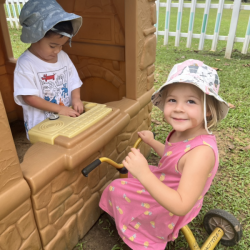 Mateo selling ice cream to Roux . Having fun with pretend play . 