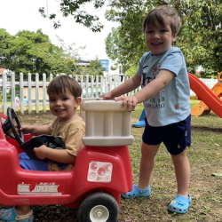 Alexander loves ‘driving’ Hugo around the garden!