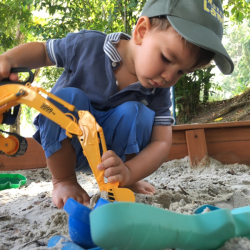 Hugo having fun in the sandpit with his excavator!