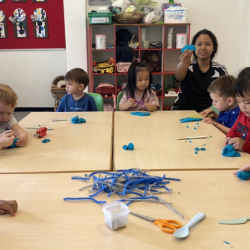 The Fireflies are practicing their cutting skills with play dough!