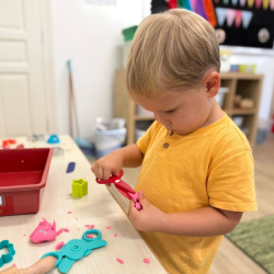 Noah practising using dough scissors - snip !