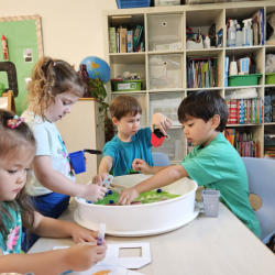 Exploring the sensory tray with recycling materials. 