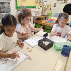 Girls are focused  on creative tracing.