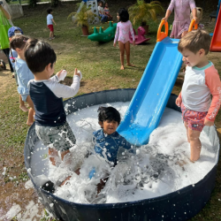 Aarav splashing down the slide.