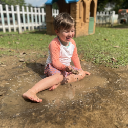 Alex having a blast playing in the mud puddle. 