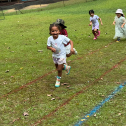 Amara having fun racing with her friends in the garden. 