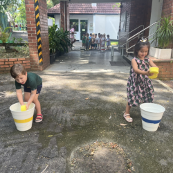 Eden and Alex having fun with water and sponge game. 
