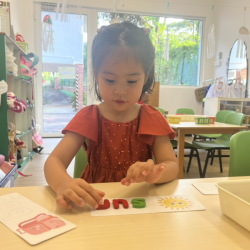 Eden’s enjoying alphabet play—building words one letter at a time!