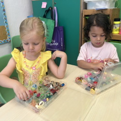 Eleanor and Alba carefully picking and sorting through a rainbow of treasures! Ms Jenny’s ring collection. 