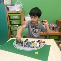 Getting creative with Lego -  Vir building a road for people to cross. 