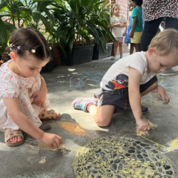 Little Artists- Klaudia and Kingston are colouring with chalk. 