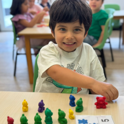 Milan practicing counting with counter bears. 