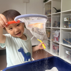 Nate having a great time with sand play . 
