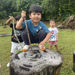 Wesley adventuring with sticks and imagination in nature!