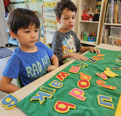 Alex and Luca having fun creating words using our alphabet mat