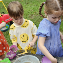 Busy bees having fun at the mud kitchen.