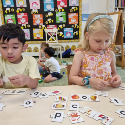 Lorenzo and Regan focusing on their alphabet matching puzzle.