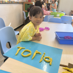 Toria spelled out her name using play-dough.