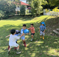 Boys having fun playing “ pass the ball”.