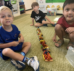 Javin, Wilbur and Rowan made animal train using blocks.