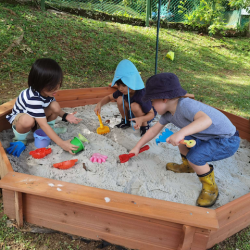 Exploring the sand pit on the big garden.