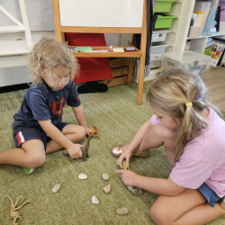 Sol and Izzy building shelter for the dinosaurs.