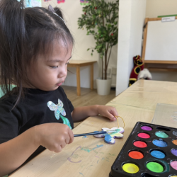 Harper painting her ornament