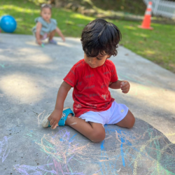 Aarav enjoying drawing with the chalk!