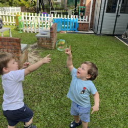 Alexander enjoying popping bubbles in the garden!