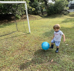 Leo practising kicking the ball!