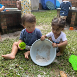 Imaan and Otto emptying all the water and sand!