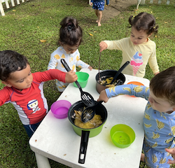 Kavi, Sara, Alba and Luca cooking leaf soup!
