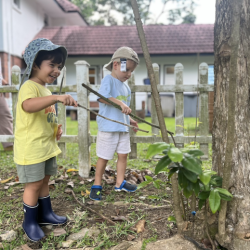 Milan and Leo pretending to cut trees. 