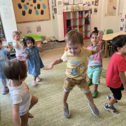 Dancing and singing during music and movement.