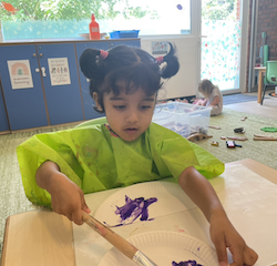Nila is painting with purple.