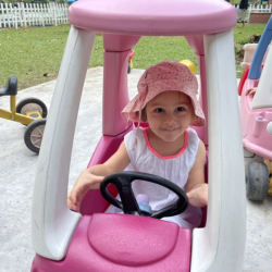 Victoire is driving in the pink car.