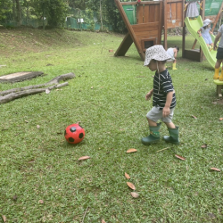 Jasper kicking the ball during outside play.